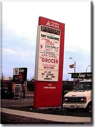 This 8'-0"x 30'-0" high aluminum structure can be found in the Upper Paradise Plaza in Hamilton, Ontario. The sign box was created from 'Sign Pro' extrusion, vinyl graphics, white acrylic and interchangeable reader board.