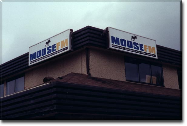 Two 3'-0" x 10'-0" sign boxes completed with three colour vinyl graphics and mounted to roof overhang.